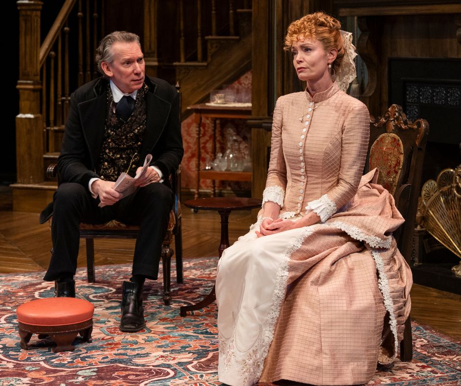 Bella is seated downstage in a needle point chair. Jack sits upstage of her, leaning forward and questioning her intently