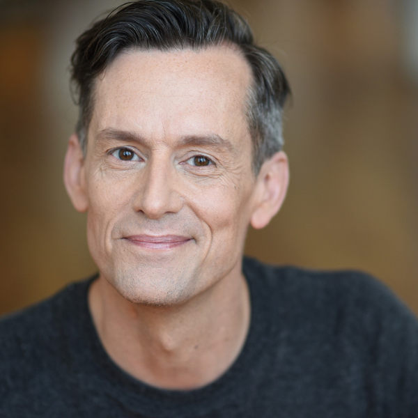 Actor Rob Lindley in front of a brown backdrop