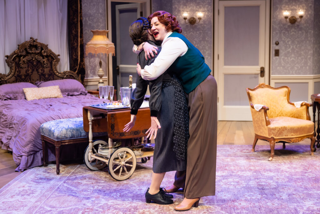 Actress Katy Sullivan embracing actress Erin Noel Grennan