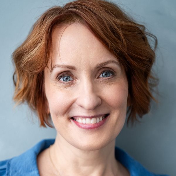 Actress Erin Noel, a woman with red hair in a blue shirt shown from the neck up