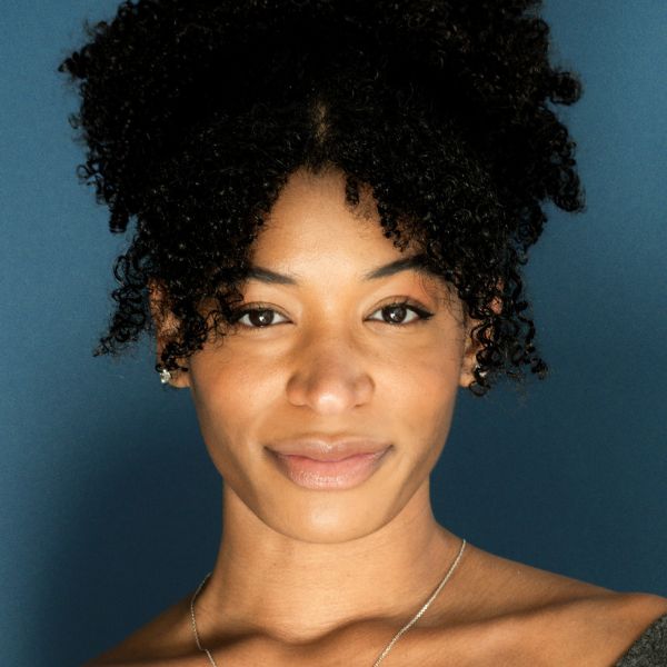 Actress Kaylah Marie Crosby's headshot, posed in front of a blue background