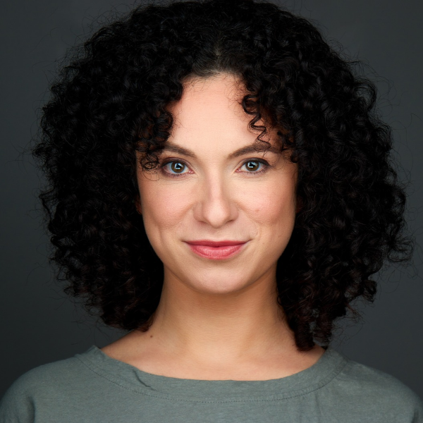 Actress Alejandra Escalante in a gray sweater in front of a grey backdrop